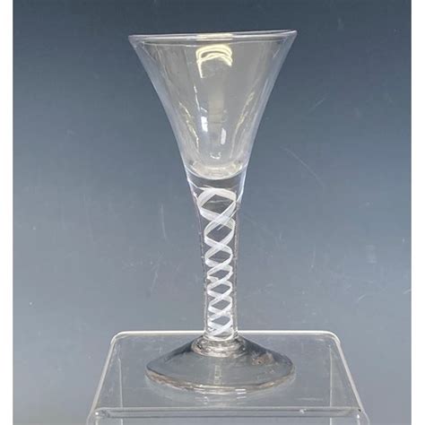 A Georgian Wine Glass With Trumpet Bowl And Opaque Twist Stem On