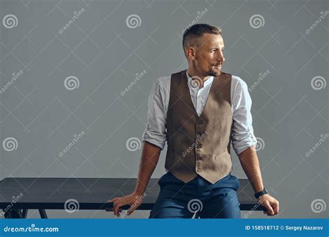 Man With A Stylish Mustache Dressed In Brown Vest White Shirt And