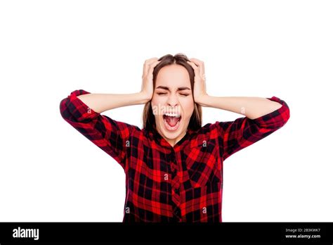 Portrait Of Frustrated Angry Young Woman Touching Head And Screaming