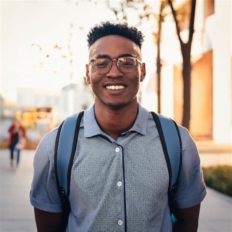 A Man Wearing Glasses And A Shirt With A Shirt That Says Quot He Is