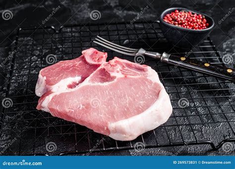 Uncooked Raw Pork T Bone Chop Meat Steak On Grill Black Background