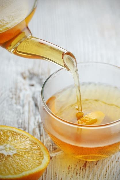 Premium Photo Pouring Tea Into Glass Cup