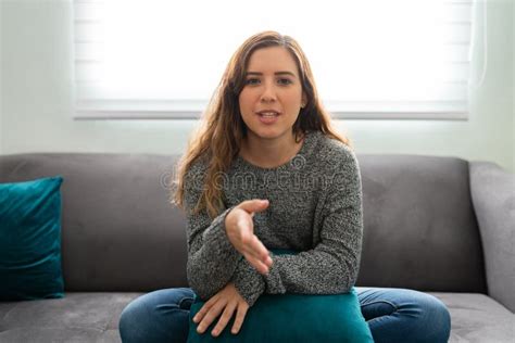 Woman Making Eye Contact And Speaking To Someone On A Video Call At