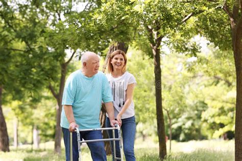 Caretaker Helping Elderly Man With Walking Frame Stock Photo Image Of