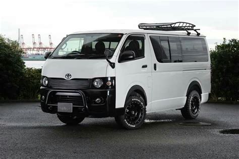 A White Van Parked On Top Of A Parking Lot