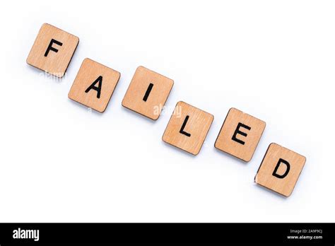 The Word Failed Spelt With Wooden Letter Tiles Over A White Background