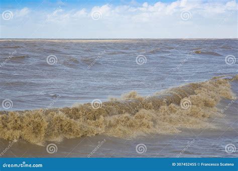 The Rough Sea Storm Surge With Waves Foam And Muddy Water Stock