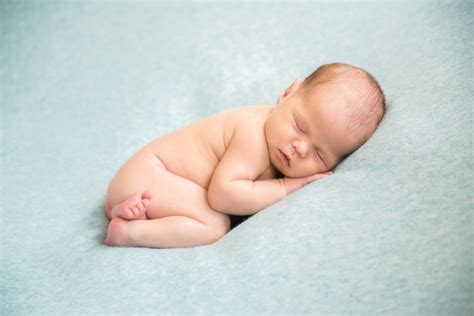 Premium Photo A Newborn Baby Is Peacefully Sleeping Naked Hands