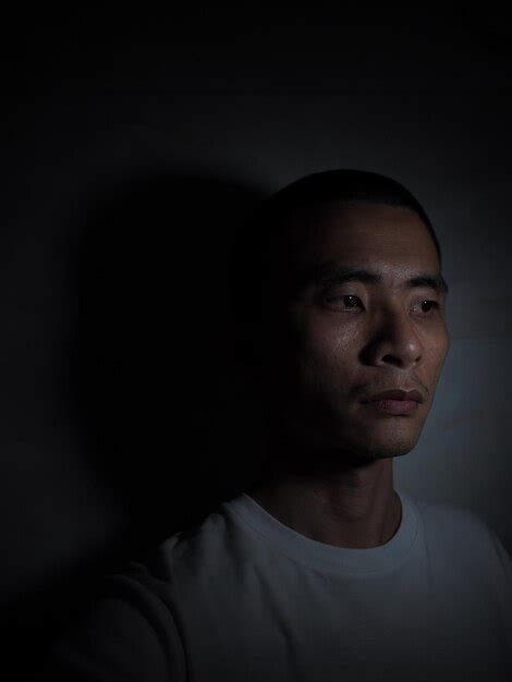 Premium Photo Close Up Of Sad Man Against Black Background