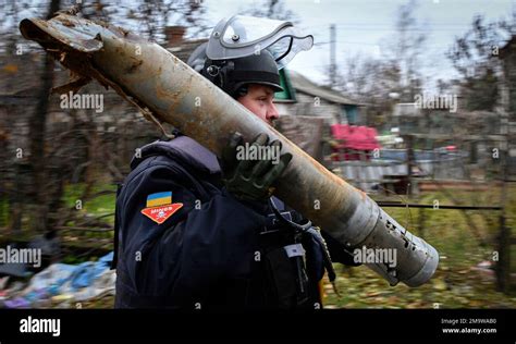 A Ukrainian Sapper Carries A Part Of A Projectile During A Demining