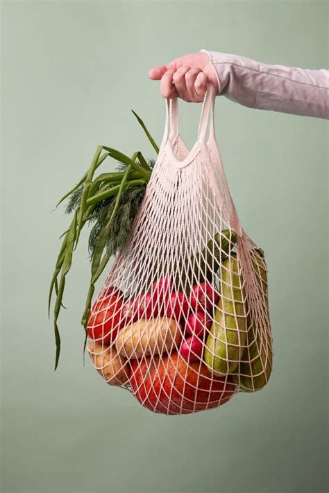 Bolsa De Malla Con Verduras Y Hierbas En Mano Hembra Imagen De Archivo