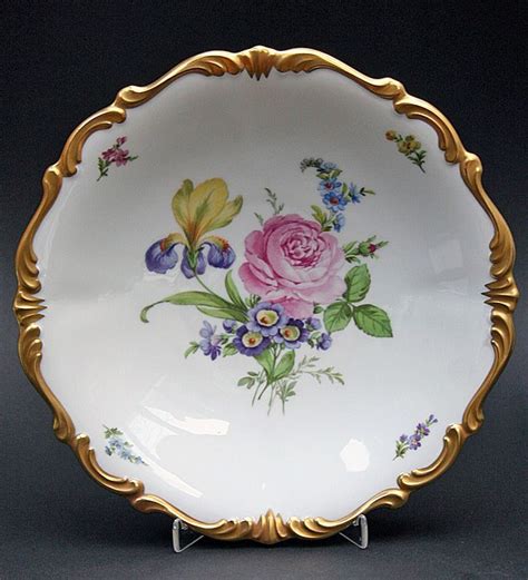 A White And Gold Plate With Flowers On It