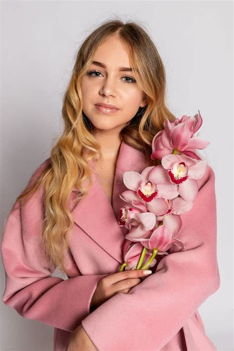 Seductive Blonde Woman In Pink Jacket Posing In Studio Stock Image