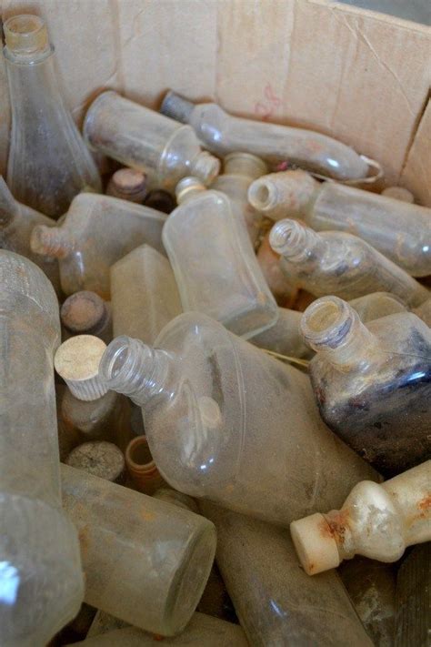 An Assortment Of Empty Glass Bottles In A Box