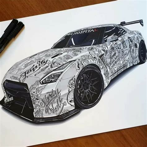 A Drawing Of A Sports Car Is Shown On A Piece Of Paper Next To A Pen