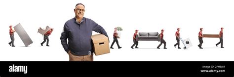 Movers Carrying Items And A Mature Male Customer Holding A Cardboard