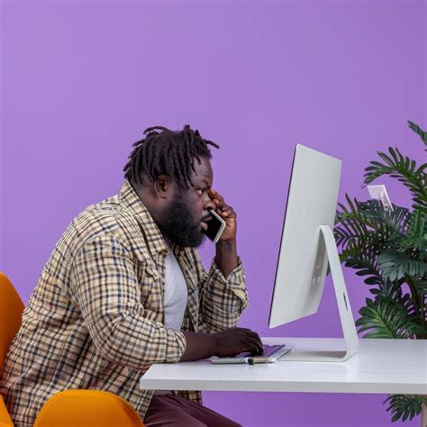 Premium Photo Man Sitting At Desk Talking On Cell Phone