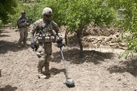 Counter Ied Teams Locate Roadside Bombs Using Metal Detectors On