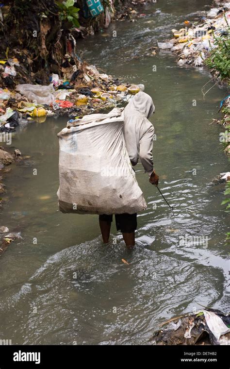 Man Throwing Garbage In The River