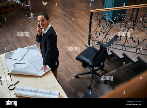 Positive Delighted Brunette Female Working At Her Project Stock Photo