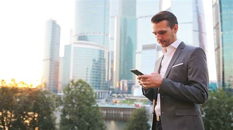 Young caucasian man holding smartphone for business work. 19646505 ...