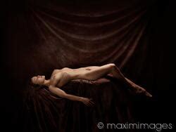 Photo Of Fine Art Nude Photograph Of A Beautiful Woman Lying Naked Posing In Artist Studio On