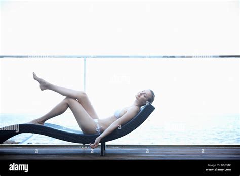 A Lady In Bikini Lying On A Beach Bed Stock Photo Alamy