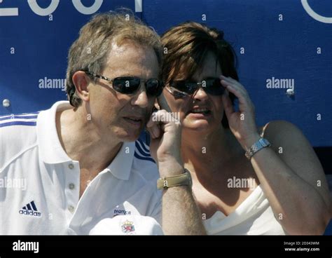 Britain's Prime Minister Tony Blair (left) and his wife Cherie sit in ...