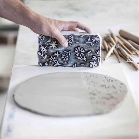 Artisan Hand Printing Porcelain With A Hand Carved Wooden Stamp Behind