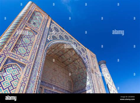 Portal And Minaret Of Ulugh Beg Madrasah Under Blue Sky On A Sunny Day