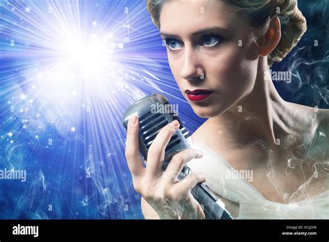 attractive female singer with microphone Stock Photo - Alamy
