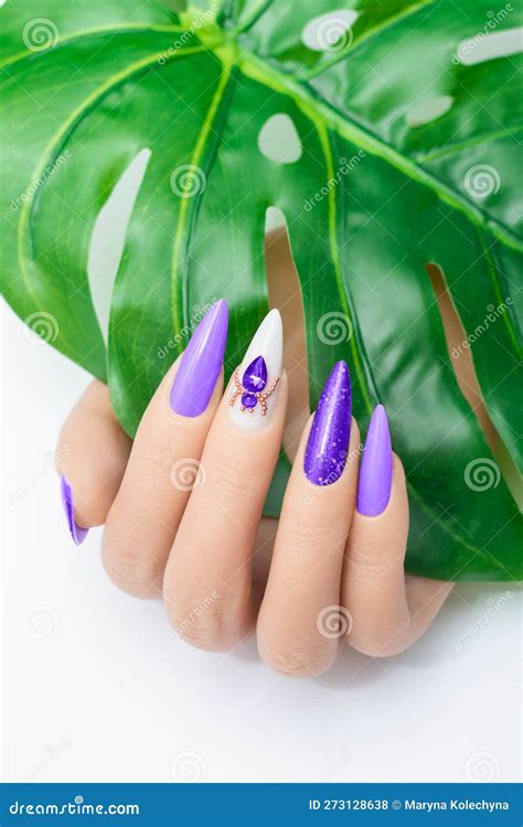 Female Hand With Stiletto Nail Design Glitter Purple Nail Polish