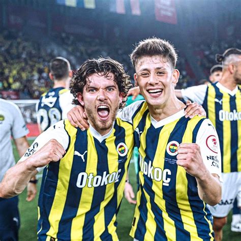 Two Soccer Players Are Posing For The Camera With Their Arms Around