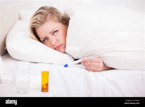 Sick Blonde Woman With A Thermometer Stock Photo Alamy