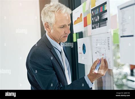 Figuring Out Some New Ideas A Mature Businessman Writing On Notes