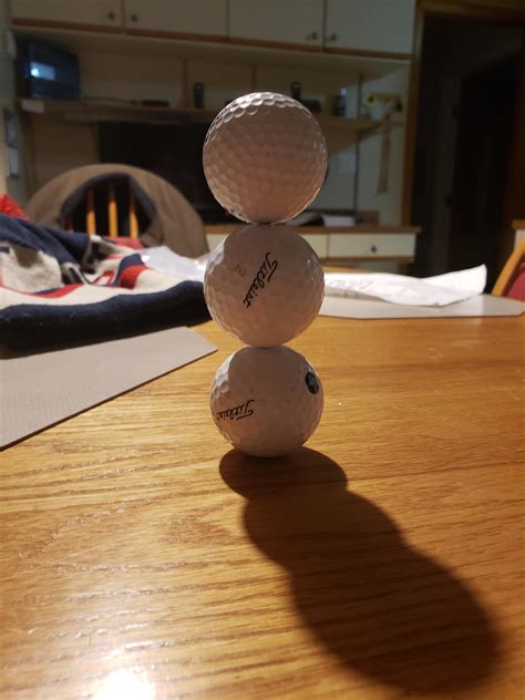 I stacked three golf balls : r/mildlyinteresting