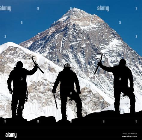 Mount Everest From Kala Patthar And Silhouette Of Men Trek To Everest