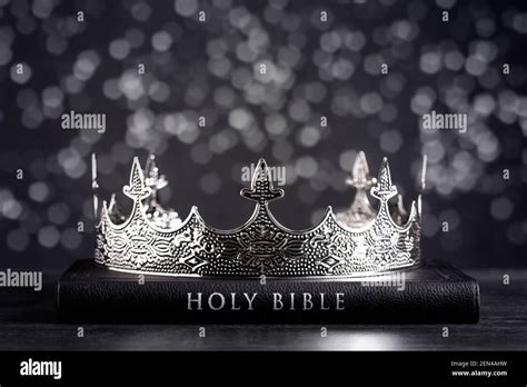 The Holy Bible And A Kings Crown On A Dark Moody Background Stock Photo