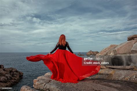 Fashion Concept Of Young Woman In Red Flying Dress With Red Hair High