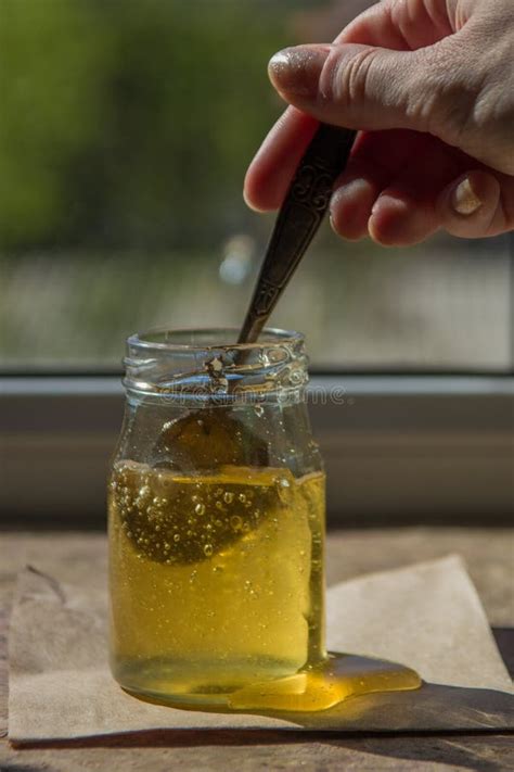 Honey Dripping From A Spoon Organic Pure Honey In Jar Stock Image