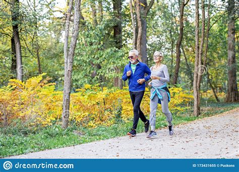 Old Couple Of Pensioners Running In Park Stock Image Image Of