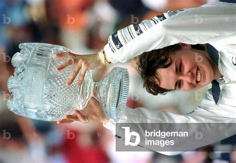 Image Of SWISS MARTINA HINGIS HOLDS ALOFT HER TROPHY FROM THE SYDNEY