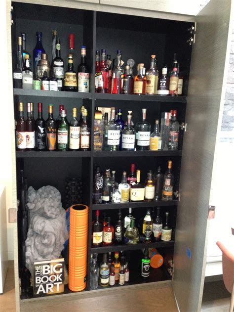 Hidden wall liquor cabinet | Kitchen island storage, Liquor cabinet ...