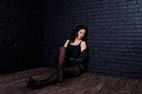 Premium Photo Studio Portrait Of Sexy Brunette Girl In Black Leather Jacket Against Brick Wall