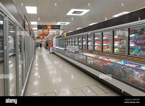 Frozen food shopping aisle in Sainsburys supermarket store interior ...