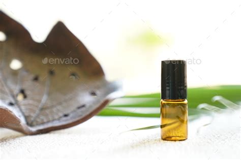 Blank Amber Glass Essential Oil Bottle On Tropical Leaf Background