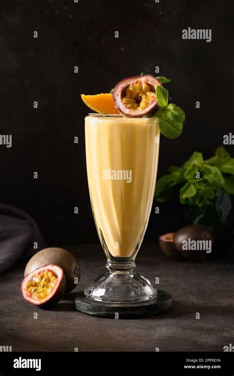 Passion Fruit And Mango Lassi Smoothie Or Milkshake On Black Background Traditional Healthy