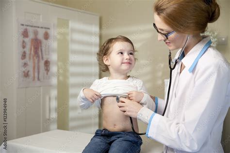 Cute little girl and doctor. Pediatrician woman examining cute little ...