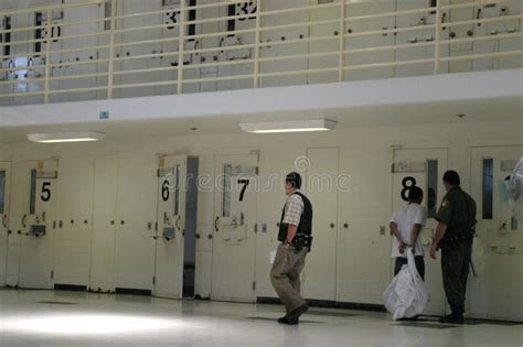 Men in Prison Cell Block with Doors Open and Numbers Hanging Editorial ...