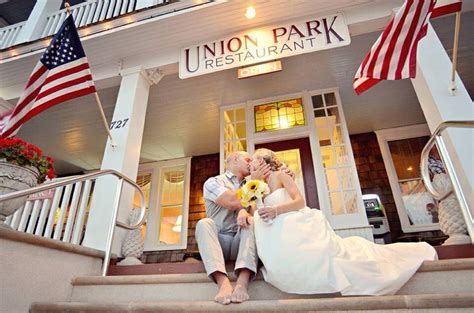 A Bride And Groom Sitting On The Steps Of Union Park Restaurant In